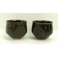 A near pair of Kenneth Quick Studio Pottery cups, mid 20th century, in brown glazed earthenware with... 