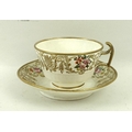 An over sized tea cup and saucer, hand painted with flowers and gilded highlights, and a part tea se... 