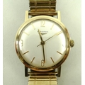 A gentleman's Longines gold cased wristwatch, the face with Arabic numerals at quarters and batons, ... 