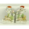 A pair of late 19th century Staffordshire flat back spill vases, modelled as a lion and lioness with... 