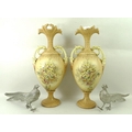 A pair of Victorian vases in the style of Royal Worcester blush ivory, decorated with flowers and fo... 