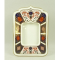 A Royal Crown Derby strut photo frame, marked 1128 LIX, 8 by 12.5cm high.