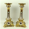 A pair of Royal Crown Derby porcelain candle sticks, decorated in the Old Imari pattern, shape no 11... 