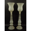 A pair of frosted glass candlesticks, with bell shaped shades decorated with low relief floral motif... 