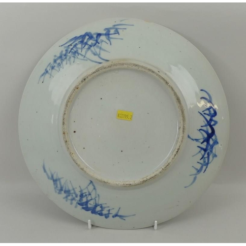 24 - An 18th century, Chinese plate, decorated in underglaze blue with a village scene, the rim with rese... 