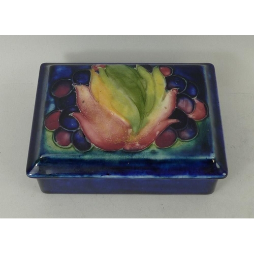 28 - A Moorcroft trinket box with cover, early 20th century, decorated with tulip and berries, bearing or... 