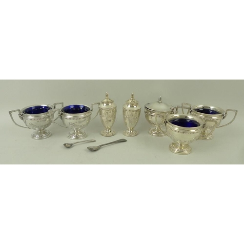 367 - A seven piece silver cruet set decorated with embossed garlands and beading, comprising four table s... 