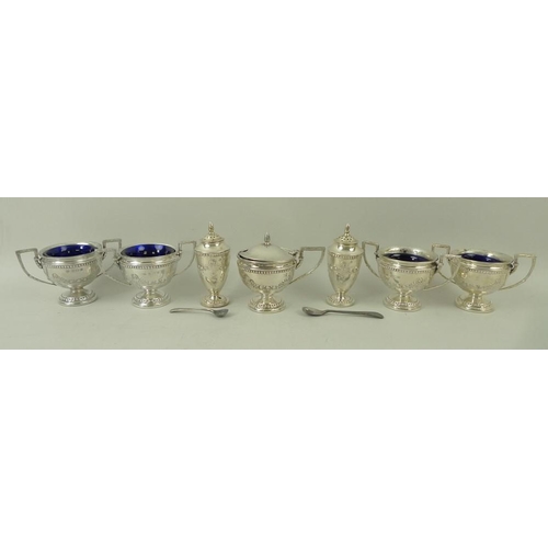 367 - A seven piece silver cruet set decorated with embossed garlands and beading, comprising four table s... 