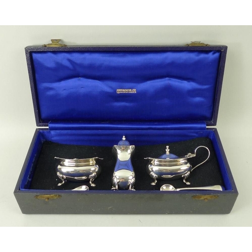 371 - A silver three piece cruet set, comprising salt and mustard with blue glass liners and spoons, and p... 