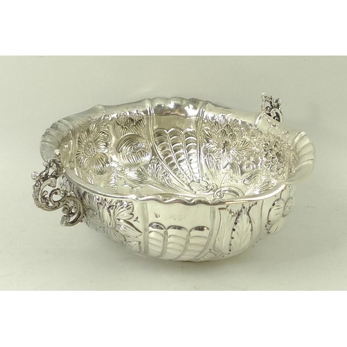 374 - A Victorian silver two handled bowl, with foliate embossed body and a roll over rim, with pinched de... 