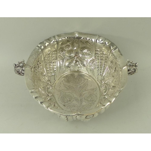 374 - A Victorian silver two handled bowl, with foliate embossed body and a roll over rim, with pinched de... 