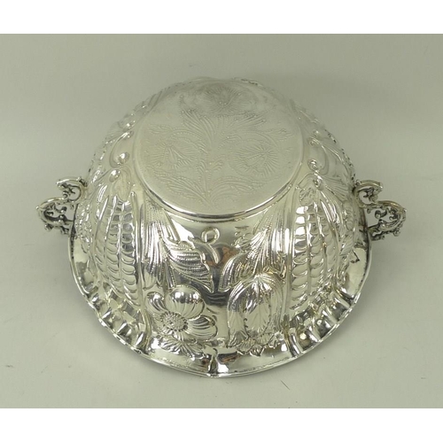 374 - A Victorian silver two handled bowl, with foliate embossed body and a roll over rim, with pinched de... 