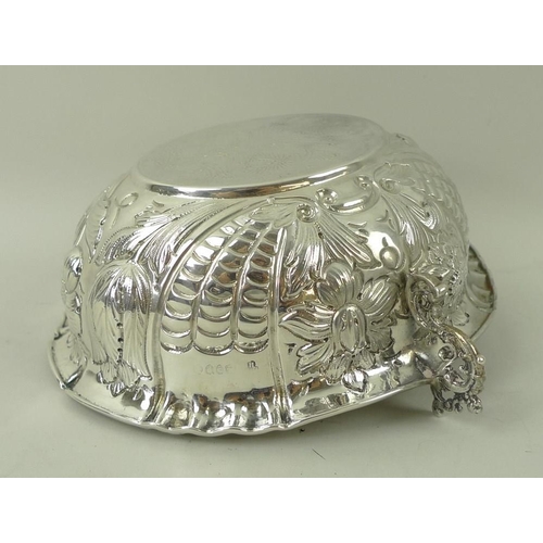 374 - A Victorian silver two handled bowl, with foliate embossed body and a roll over rim, with pinched de... 