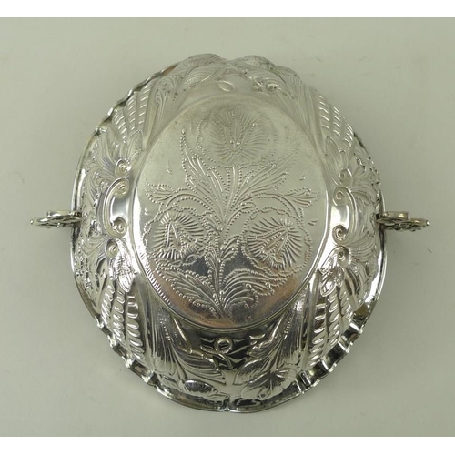 374 - A Victorian silver two handled bowl, with foliate embossed body and a roll over rim, with pinched de... 