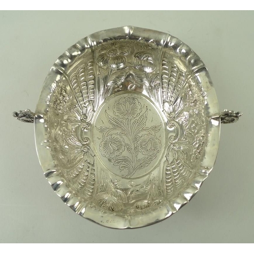 374 - A Victorian silver two handled bowl, with foliate embossed body and a roll over rim, with pinched de... 