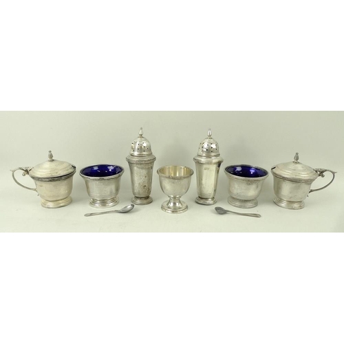 380 - A six piece silver cruet set, comprising two peppers, two mustards with blue glass liners, and two o... 