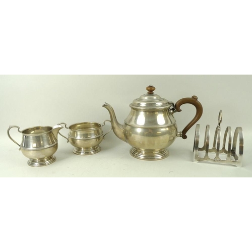 383 - A three piece silver tea service, teapot with wooden handle and finial, Birmingham 1939, S Ld for Wi... 