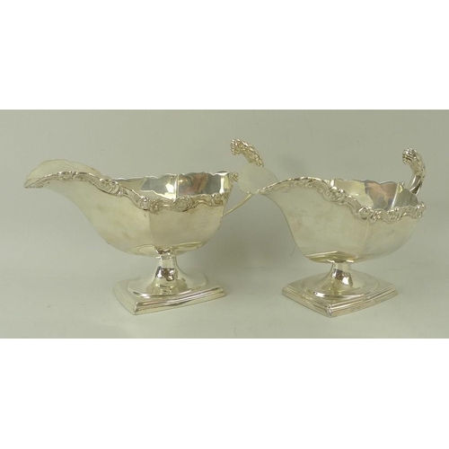 389 - A pair of Edwardian silver sauce boats, the handles with cast jaguar heads, with cast scroll rim, ra... 