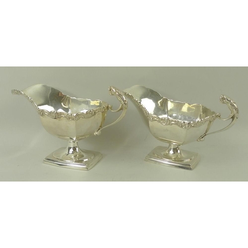 389 - A pair of Edwardian silver sauce boats, the handles with cast jaguar heads, with cast scroll rim, ra... 