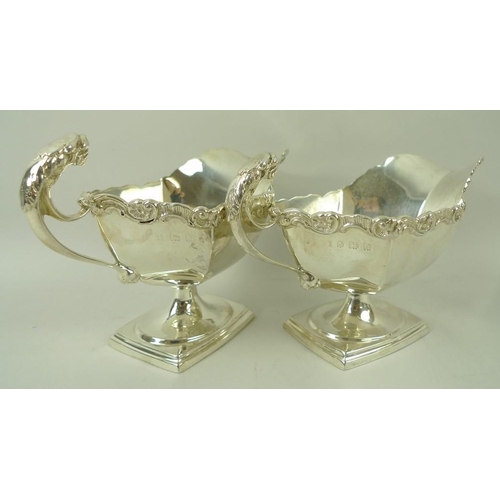 389 - A pair of Edwardian silver sauce boats, the handles with cast jaguar heads, with cast scroll rim, ra... 