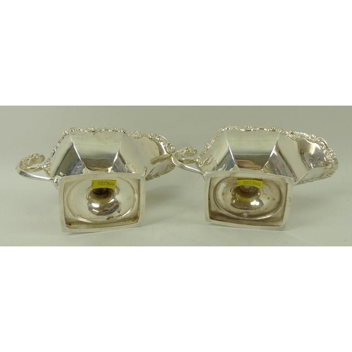 389 - A pair of Edwardian silver sauce boats, the handles with cast jaguar heads, with cast scroll rim, ra... 