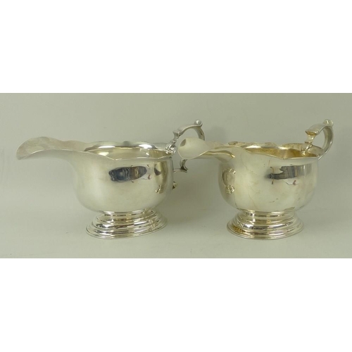 394 - A pair of silver sauce boats, on oval stepped base, London 1922, LAC for Lionel Alfred Crichton, sta... 