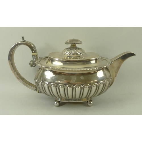 398 - A George III silver teapot, London 1808, R.H.S.H. for Robert Samuel Hennell, with gadrooned body, ap... 