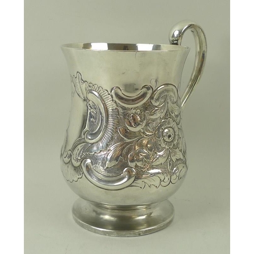 401 - A silver tankard, embossed with floral and foliate scrolling with vacant reserve, of baluster form, ... 