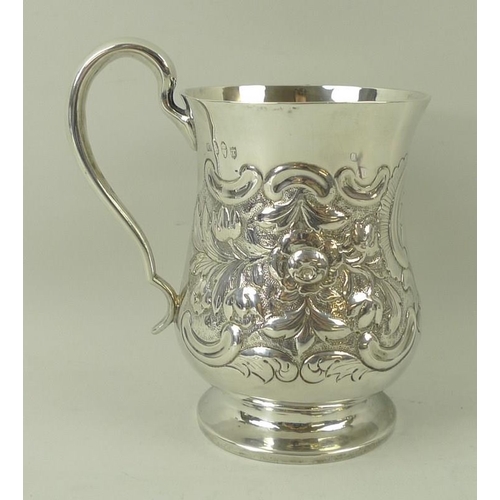 401 - A silver tankard, embossed with floral and foliate scrolling with vacant reserve, of baluster form, ... 