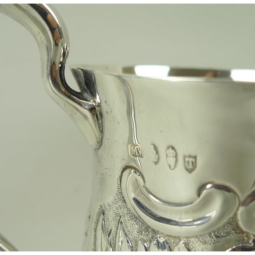 401 - A silver tankard, embossed with floral and foliate scrolling with vacant reserve, of baluster form, ... 