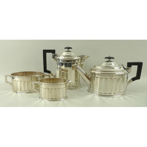 405 - An Art Deco four piece silver tea set, with fluted sides and angular handles, the pots with ebony ha... 