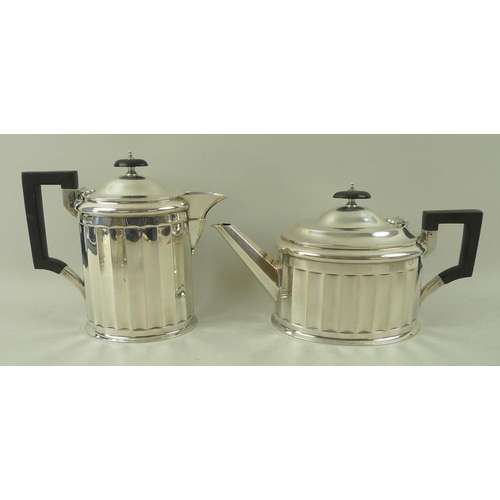 405 - An Art Deco four piece silver tea set, with fluted sides and angular handles, the pots with ebony ha... 