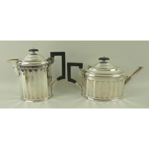 405 - An Art Deco four piece silver tea set, with fluted sides and angular handles, the pots with ebony ha... 