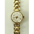 A lady's 9ct gold watch, by Waltham, the circular face with Arabic numerals at evens and batons at o... 