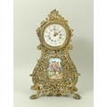 A French travelling clock, 20th century, with ornate scrollwork, the face with Roman numerals and Ar... 
