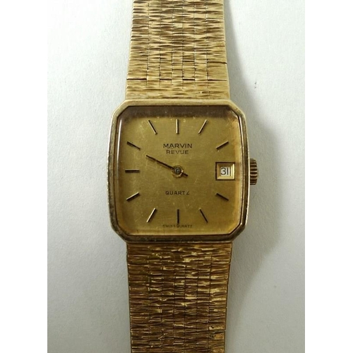 440 - A Marvin Revue wristwatch, the square with baton numerals and date aperture, on a 9ct gold bracelet ... 