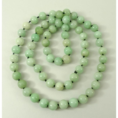 444 - A Chinese 1920's milk green serpentine necklace, sixty-seven beads, 92cm long.