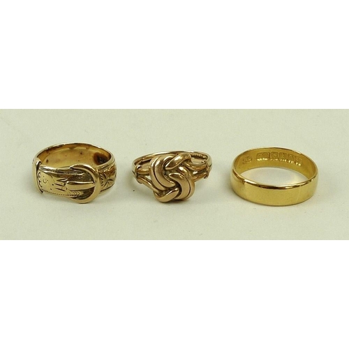 446 - A group of three gold rings, comprising a 9ct gold love knot ring, size K, a 9ct gold belt ring, siz... 