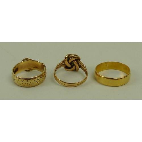 446 - A group of three gold rings, comprising a 9ct gold love knot ring, size K, a 9ct gold belt ring, siz... 