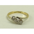 An 18ct gold, platinum and diamond three stone ring, the diamonds set at an angle across the band, s... 