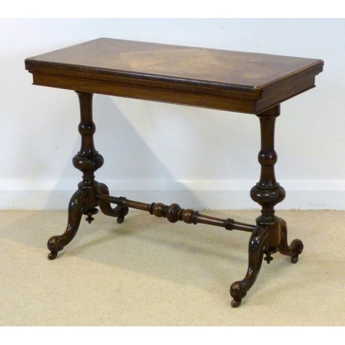 652 - An early Victorian walnut fold over card table, the rectangular top of burr walnut, inlaid with a qu... 