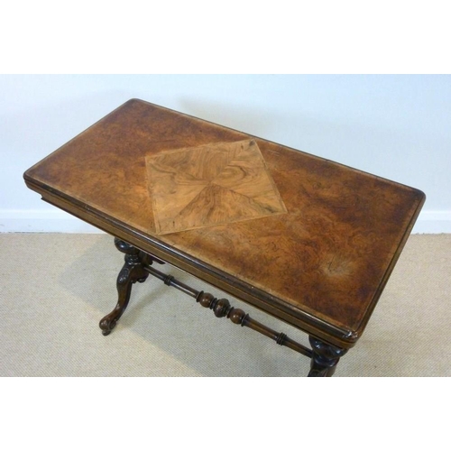 652 - An early Victorian walnut fold over card table, the rectangular top of burr walnut, inlaid with a qu... 