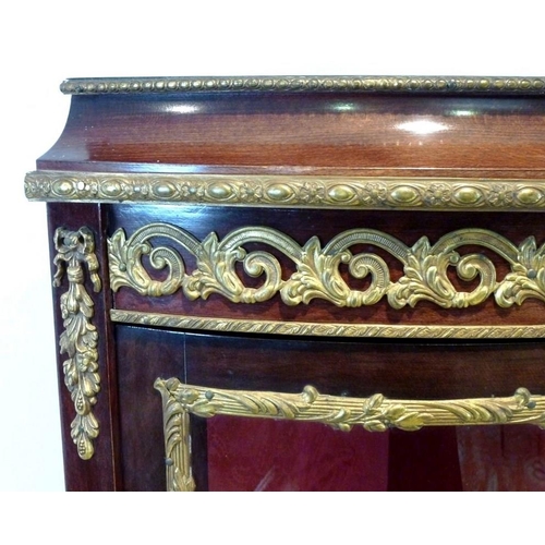 653 - A Louis XVI style, mid 20th century, cylinder front corner display cabinet, with gilded metal mounts... 