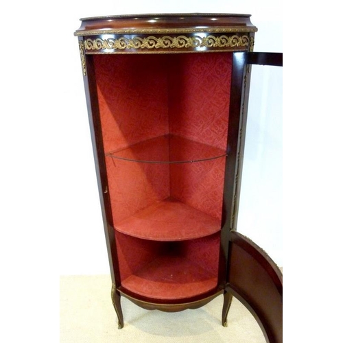 653 - A Louis XVI style, mid 20th century, cylinder front corner display cabinet, with gilded metal mounts... 