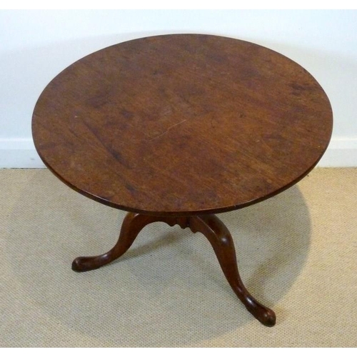 654 - A Georgian mahogany circular occasional table, tilt top, raised on a single turned column and three ... 