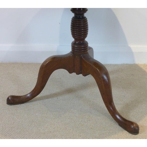 654 - A Georgian mahogany circular occasional table, tilt top, raised on a single turned column and three ... 