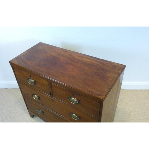 655 - A 19th century mahogany chest of two short over two long drawers, with oval brass handles, each embo... 