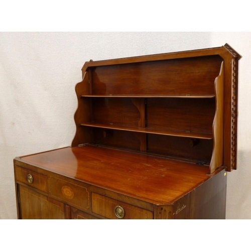 662 - A French 19th century mahogany and inlaid commode / dressing cupboard of canted edge form, with lift... 