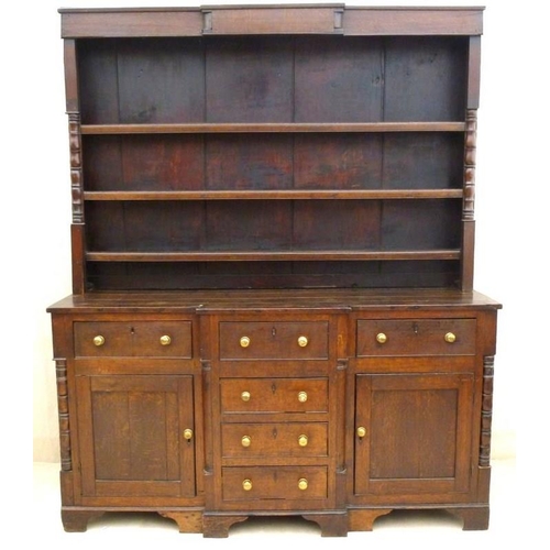 665 - An 18th century oak breakfront dresser, plate rack with three shelves and turned pilaster decoration... 