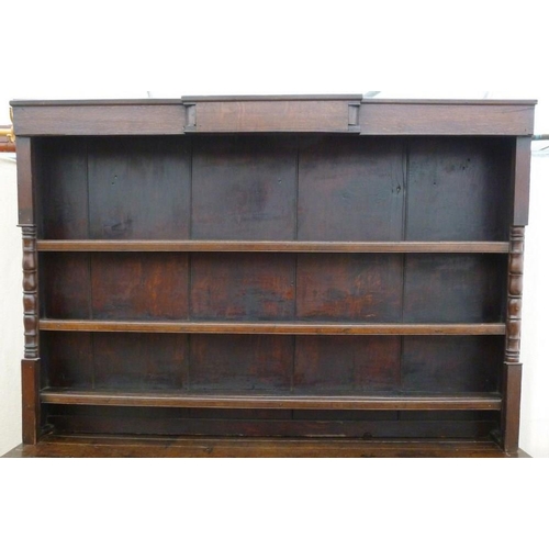 665 - An 18th century oak breakfront dresser, plate rack with three shelves and turned pilaster decoration... 